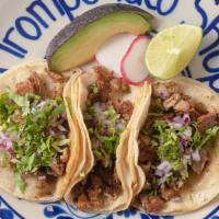Taco · Your choice of meat served in a soft corn tortilla topped with onions and cilantro.
