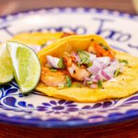 Shrimp Taco · Grilled shrimp served on corn tortilla topped with onions and cilantro.