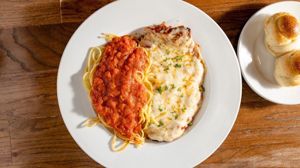 Chicken Parmigiana · Hand pounded cutlet, breaded & sautéed. baked with tomato sauce, topped with mozzarella, and served with spaghetti or penne.