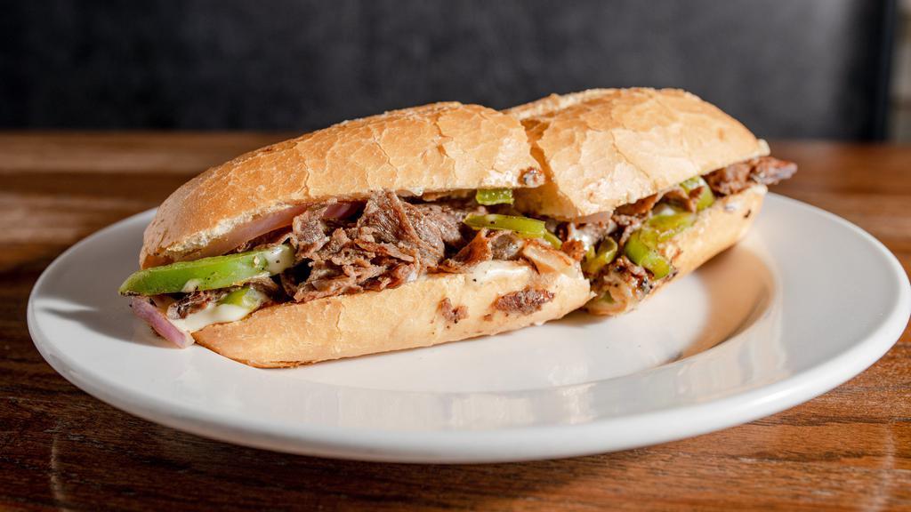 Philly Cheesesteak · shaved top sirloin, onions, green peppers, American cheese & mayo.