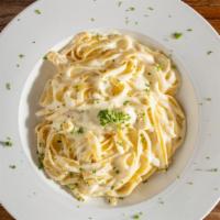 Fettuccine Alfredo · Fettuccini tossed in a rich butter, cream & parmesan cheese sauce.
