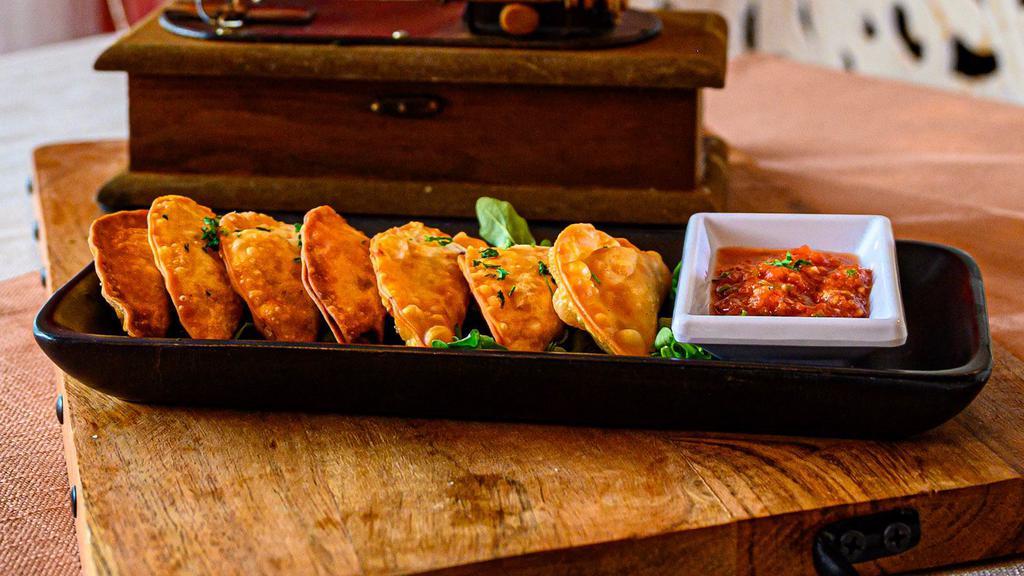 Itty Bitty Fried & Pretty · Chebureki - six fried mini puff pastries filled with beef and traditional spices.