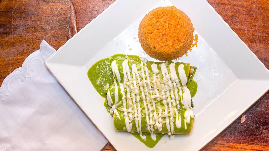 Spinach & Chicken Enchiladas · Three corn tortillas stuffed with grille chicken and spinach, topped with a creamy poblano sauce, cheese and sour cream. Served with rice.