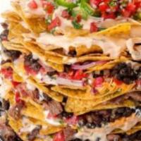 Nacho Stack · Massive stack of cool ranch tortilla chips, cheddar jack, shredded lettuce, pico salsa, blac...
