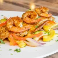 Catch Noel Plate · Grilled gulf fish topped with a garlic butter sauce, shrimp, and over sautéed veggies.