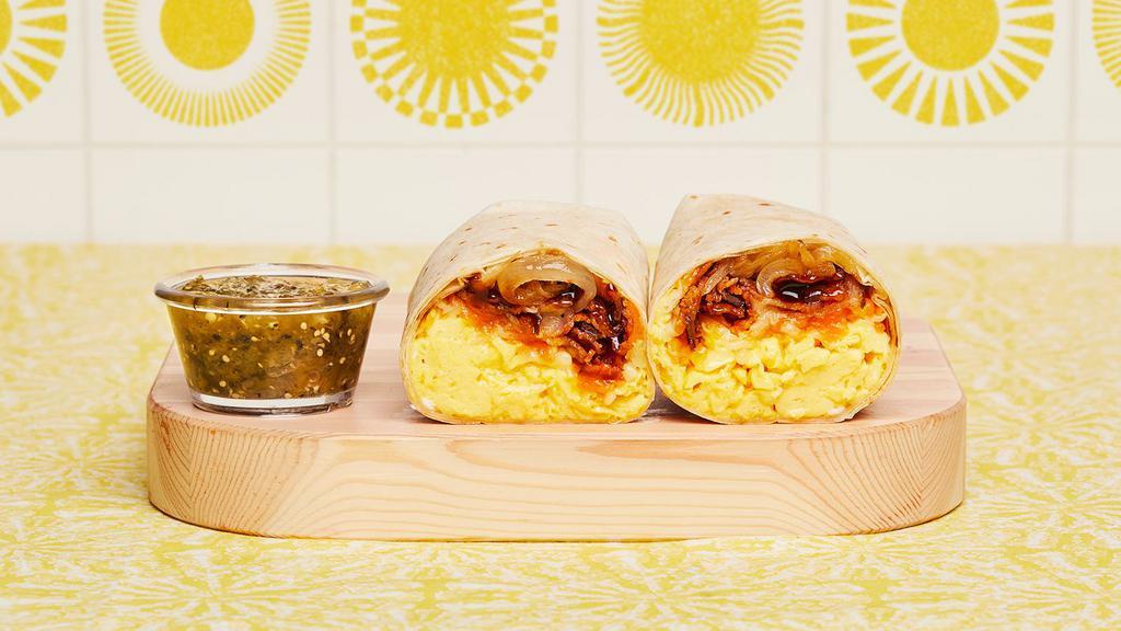 Bacon Bbq Breakfast Burrito · Two scrambled eggs, breakfast potatoes, crispy bacon, BBQ sauce, grilled onions, and melted cheese wrapped in a fresh flour tortilla.