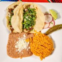 Quick Tacos · Two asada street tacos with cilantro and onions served with rice and beans.
