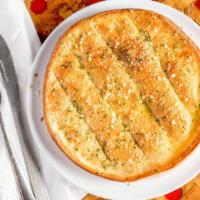 Garlic Bread · Fresh-baked pizza dough brushed with zesty garlic sauce and topped with mozzarella.