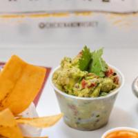 Guasacaca + Chips · Fresh avocado, red onion, chopped cilantro, red bell pepper, lime juice, salt and black pepp...
