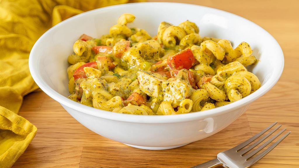 Pesto Chicken · Classic pesto pasta featuring cavatappi topped with Swiss and parmesan cheese, diced chicken, diced tomato, and brown butter garlic bread crumbs.