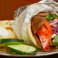 Gyro · Beef, lamb or chicken on pita bread with tzatziki sauce. Comes with lettuce and tomato. Serv...