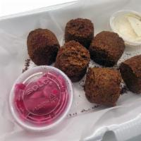 Falafel Balls (6 Pcs) · Chickpeas patties fried and served with tahini sauce. Comes with pita bread.