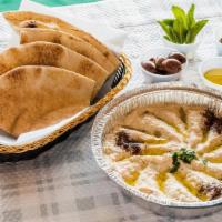Baba Ghanoush · Open flame-roasted eggplant, tahini, garlic, and lemon juice. Comes with pita bread.