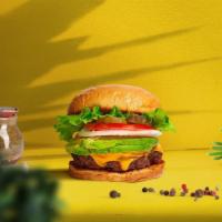 Cadet Cado Burger · Plant-based patty, avocado, lettuce, tomato, onion, and pickles on a burger bun.