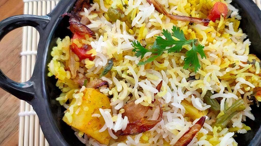 Vegetable Biryani (V, Gf) · A vegetarian delight. Seasonal vegetables simmered in gravy & basmati rice, layer upon layer, make for a royal treat. . Served with Raita.