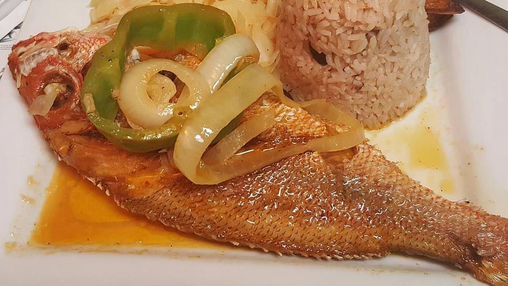 Brown Stew Fish · Fish is seasoned, fried, and cooked in a delicious brown sauce with onion, garlic, and peppers.