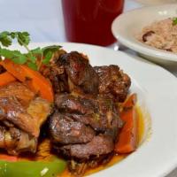 Brown Stew Chicken · Delicately seasoned in a mixture of island herbs and spices, cooked with vegetables in a ric...