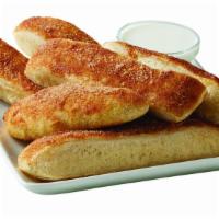 Cinnamon Sticks · Freshly-baked house-made dough topped with cinnamon sugar. Comes with sweet icing dipping sa...