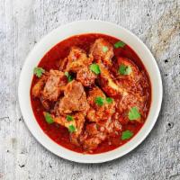 Capital Lamb Curry · Pieces of lamb sauteed with fresh garlic, ginger, and tomatoes.