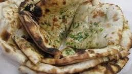 Naked Naan · Leavened and oven-baked naan flatbread.