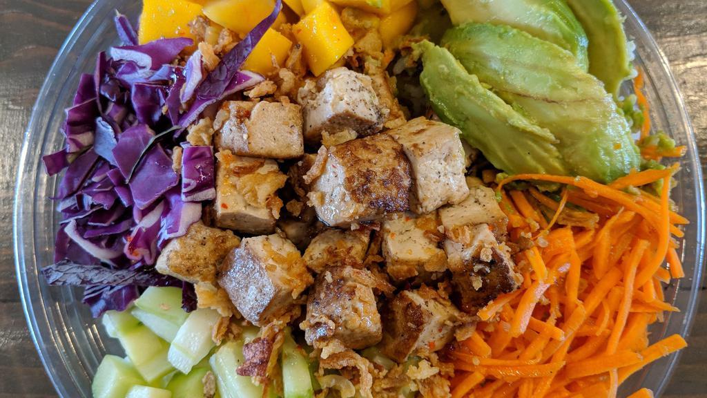 Tropical Tofu · Any base with grilled tofu marinated in Triple Citrus sauce. Topped with carrots, cucumber, cabbage, mango, avocado, crunchy onions, drizzled with Island Sweet Chili sauce.