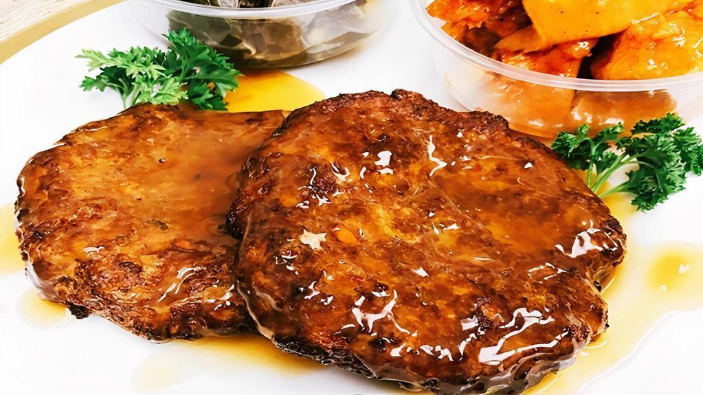 Salisbury Steak (1) · Seasoned ground beef gets shaped into steak-like patties, browned, and then braised in a rich beef gravy, served with two side dishes and choice of bread on the side.