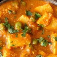 Mutter Paneer · Gluten free. Green peas and cubes of handmade Indian cheese in a mildly spiced gravy.