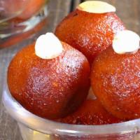 Gulab Jamun · Deep fried handmade cheese balls in a honey and rosewater syrup.