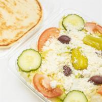 Greek Salad · With lettuce, tomato, cucumber, green peppers, red cabbage, pepperoncini, pita bread and Gre...