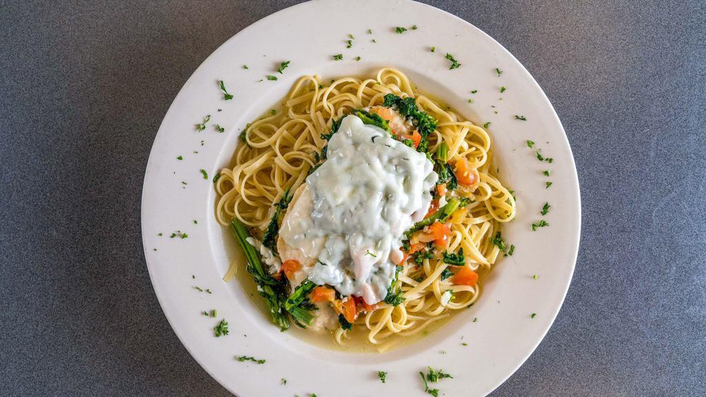 Chicken Rapini · Boneless chicken breast sautéed with broccoli robe and fresh tomatoes, topped with mozzarella cheese in a garlic and oil sauce, served over pasta.