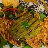 Pollo Asada · Marinated chicken breast rajas poblanos, Spanish rice, black beans with a side of grilled ca...