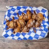 Homemade Loukoumades · Light pastry puffs served with honey syrup and cinnamon.