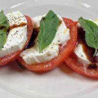 Caprese Salad · vine ripe tomatoes & fresh mozzarella  with an olive oil and balsamic drizzle