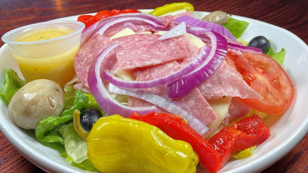 Antipasto Salad · ham, provolone, genoa salami, roasted red peppers, marinated mushrooms, red onions, black olives, plum tomatoes & pepperoncinis, over a bed of lettuce