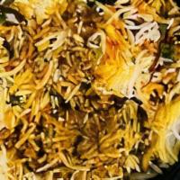Chicken Biryani  · Succulent pieces of chicken and basmati rice cooked in a seated pot and garnished with cilan...