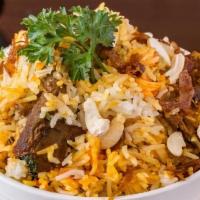 Goat Biryani · Succulent cubes of goat and basmati rice cooked in a seated pot garnished with cilantro, min...