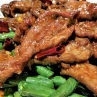 Yuen-Yang Spicy Beef · Hot and Spicy. In a hot pepper sauce on a bed of string beans