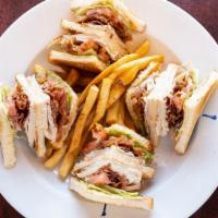Turkey Club · Bacon, lettuce, tomatoes and mayo. On white or wheat bread, served with choice of lisa's nat...