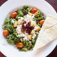 Arugula Salad · Goat cheese, croutons, dried cranberries and cherry tomatoes.