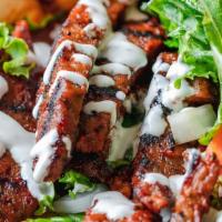 Lamb Gyro Only · Lamb gyro on pita bread, Lamb seared over charcoal grille topped with Green Leaf Lettuce, to...