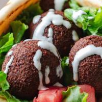 Falafel Gyro Only · Falafel on pita bread topped with Green Leaf Lettuce, tomato, onion, white sauce, (Optional)...