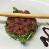 Tuna Tartar Avocado · Sashimi tuna, avocado, arugula, sesame oil, and soy sauce dressing.