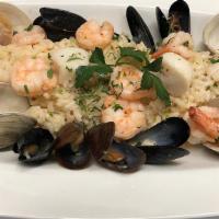 Seafood Risotto · Arborio rice, clams, calamari, mussels, scallops, rock shrimp, garlic, and white wine sauce.