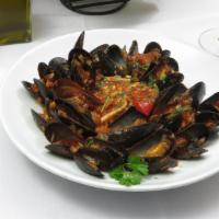 Linguini With Mussels · Linguini with mussels in a light tomato sauce, evoo, crushed red pepper, parsley.