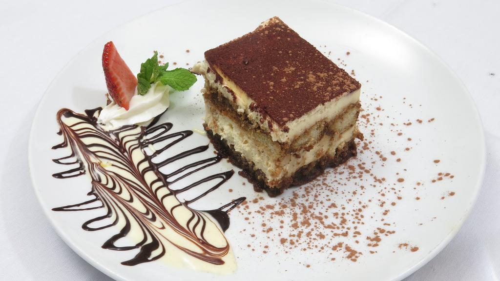 Tiramisu · Layers of espresso drenched sponge cake and mascarpone cheese dusted with cocoa powder
