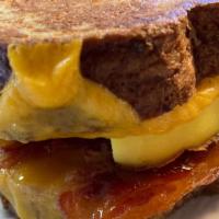French Toast Breakfast Sandwich · A french toast breakfast sandwich made on our house-made brioche bread with egg, cheddar che...