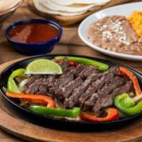 Classic Steak Fajita · Our famous fajitas are grilled over mesquite wood and served with hand-pressed flour tortill...