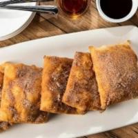 Sopapillas (5 Ea.) · Five Mexican pastries coated in cinnamon-sugar. Served with honey and chocolate sauce for di...