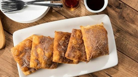 Sopapillas (5 Ea.) · Five Mexican pastries coated in cinnamon-sugar. Served with honey and chocolate sauce for dipping.