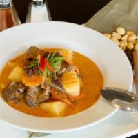 Massaman Curry · Spicy, contains peanut. Your choice is sautéed in a Thai-Malaysian curry sauce with potatoes...